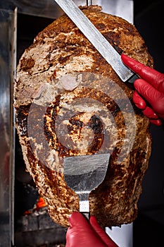 Fried meat on a skewer for cooking of donors or shawarma. Close-up