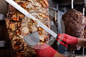 Fried meat on a skewer for cooking of donors or shawarma. Close-up