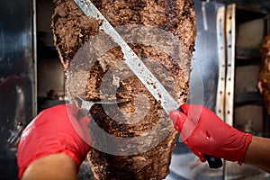 Fried meat on a skewer for cooking of donors or shawarma. Close-up