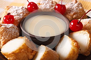 Fried milk with condensed milk and cherries macro. horizontal