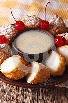 Fried milk dessert with condensed milk close-up. vertical