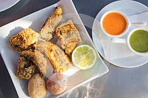 Fried moray eel with salt potato, accompanied by mojo picon and green mojo. Typical dish of the cuisine of the Canary Islands