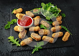 Fried mozzarella cheese sticks in breadcrumbs with ketchup sauce and wild rocket leaves