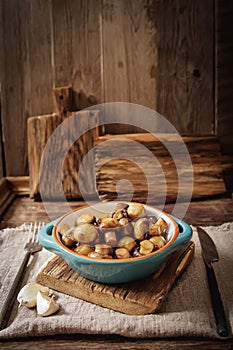 fried mushrooms with salt and pepper on a wooden background