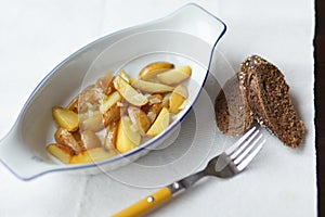 Fried new potatoes in oval pan on the table