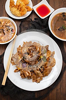 Fried noodles with vegetables and beef in white dish