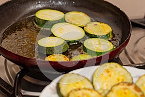 Fried in oil vegetable marrows in the kitchen