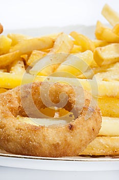 Fried onion ring with french fries in the plate