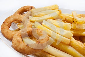 Fried onion ring with french fries in the plate