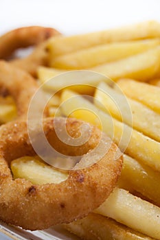 Fried onion ring with french fries in the plate