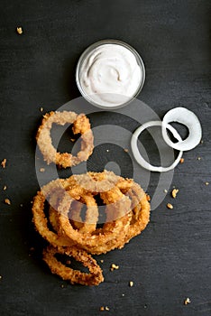 Fried onion rings with sauce, top view