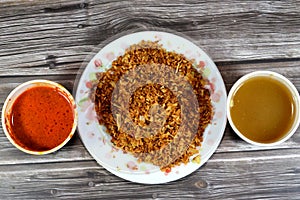 Fried onions, spices and peppers sauce called Shatta and Cumin vinegar sauce, Also called Dakkah sauce, made of white vinegar,