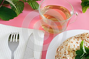 Fried pancakes close-up on a white plate, pancakes with raspberries, tea cerimonia, dessert on a pink background