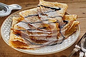 Fried pancakes drizzled with chocolate sauce