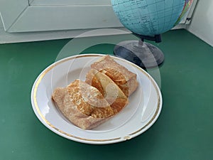 Fried pancakes with filling on a plate