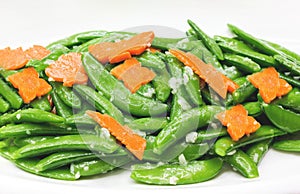 Fried pea and carot with garlic on white, vegetarion healthy foo