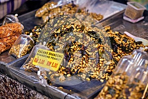 Fried peanut with chilly pepper - traditional asian street food.