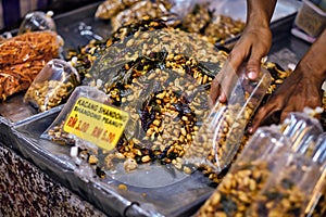 Fried peanut with chilly pepper - traditional asian street food