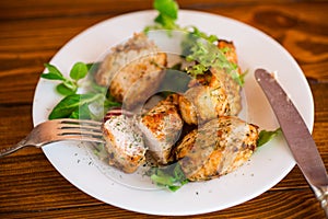 Fried pieces of chicken fillet breaded with spices and herbs in a plate .