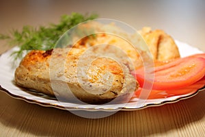 Fried pieces of chicken in a plate on the table.