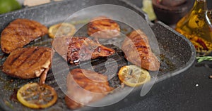 Fried pieces of Organic Tuna Steak on a hot grill frying pan