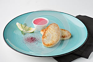 Fried pike cutlets with lemon, verdure and pink sauce