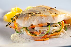 Fried pike perch fillet with vegetables.