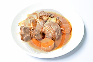 Fried pork bone with slice carrot and onion with swet and sour sauce on plate