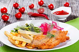 Fried pork chop with french fries, green bean and salad