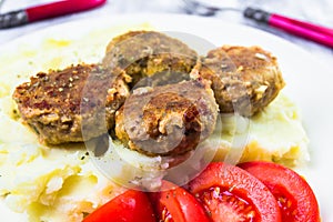 Fried pork chops boiled potatoes tomatoes