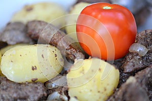 Fried pork liver with tomatoes and potatoes