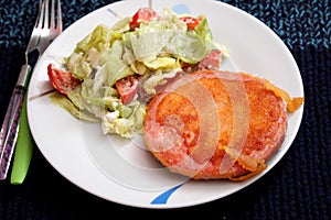 Fried pork meat with salad