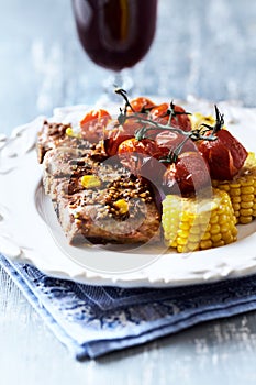 Fried pork ribs with cherry tomatoes and sweet corn.
