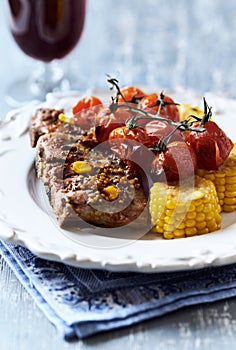 Fried pork ribs with cherry tomatoes and sweet corn.