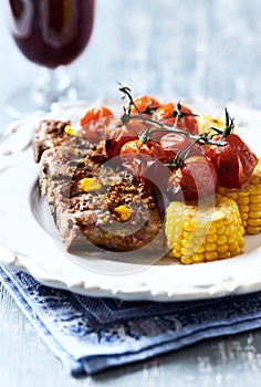 Fried pork ribs with cherry tomatoes and sweet corn.