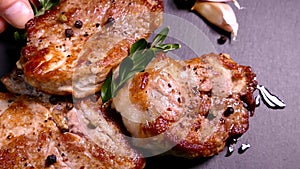 Fried pork steak on a plate. Meat dish close-up. Juicy chop.