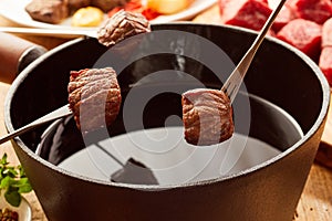Fried portions of tender beef cooked in a fondue photo