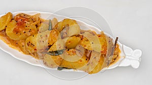 Fried Potato Curry in leaf shape ceramic bowl, Top View.