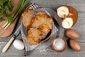 Fried potato pancakes on the old wooden background