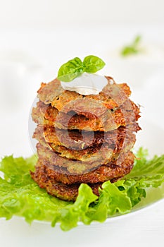 Fried potato pancakes with sour cream