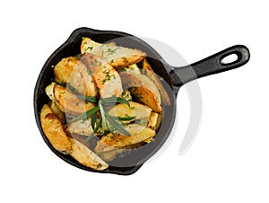 Fried potatoes with fresh rosemary in cast-iron pan