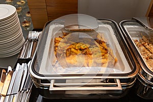 Fried potatoes garnish in a food warmer