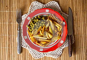 Fried potatoes with green peas