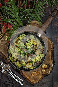 Fried potatoes with mushrooms in a pan.the view from the top.Mushroom time in autumn