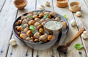 Fried potatoes with mushrooms, pine nuts and cream sauce