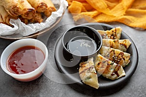 Fried potstickers with balsamic glaze covered in seeds and chives