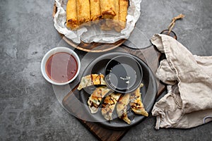 Fried potstickers with balsamic glaze covered in seeds and chives