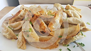 Fried Potstickers On White Plate