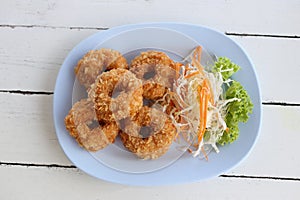 Fried Prawn Cake (tod mun kung) in blue dish.