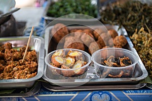 Fried quail eggs, fish, shrimp, vegetable in market at Ko Kred